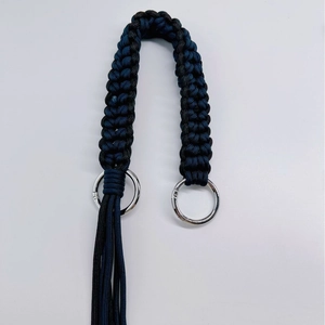 Handwoven black and dark blue crossbody shoulder strap with silver metal rings and tassels