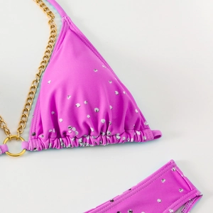 Detailed view of pink leopard bikini top with elegant gold metal chain straps