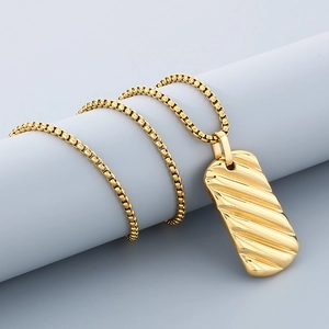 Detailed close-up of 18K gold stainless steel square pendant with wavy 3D texture