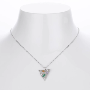 Detailed shot of a silver triangle pendant necklace with colorful gemstones on a bust