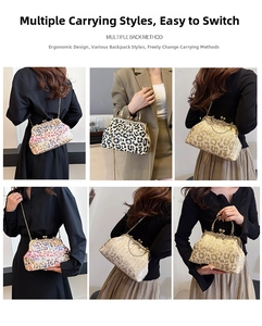 Detail of vintage leopard print clutch with gold chain strap and spherical metal clasp