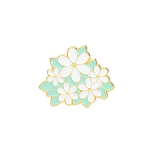 Detailed view of enamel sunflower and lily brooch with yellow center and gold edges