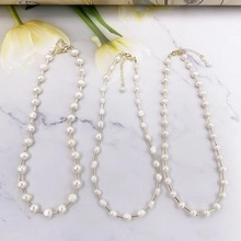 Detail of freshwater pearl necklace with 14k gold plated tubes and lobster clasp