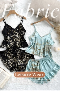Floral print satin camisole and shorts pajamas set on a soft white plush rug