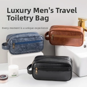 Close-up of premium leather toiletry bags in blue, brown, and black with gold zippers