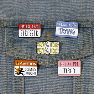 Detailed view of colorful speech bubble enamel pins on denim jacket pocket