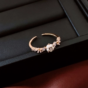 Detail of 14K gold-plated flower ring with white enamel petals and zirconia accents