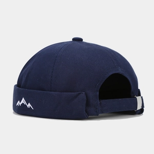 Detail of navy blue miki hat showing white mountain embroidery and metal buckle strap
