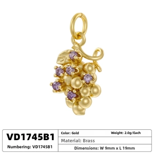 Macro view of gold-plated grape pendant featuring purple zircons and brass vines