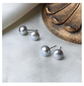 Macro shot of grey freshwater pearl studs on white silk with S925 silver needles