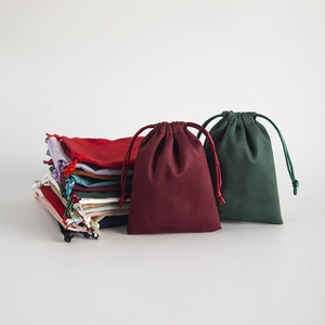 Multiple colorful flannel drawstring pouches for jewelry and gift packaging display
