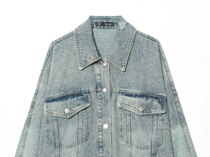 Detailed flat lay of light blue denim jacket with metal buttons and chest pockets