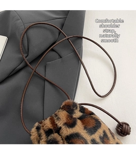 Detail of leopard print faux fur bag showing the thin strap and exquisite woven knot