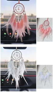 Detail of pink and white crystal feather dreamcatcher car charms hanging on rearview mirror