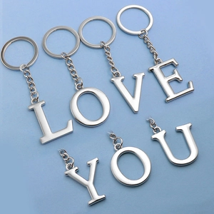 Polished metal alloy letter keychain set spelling LOVE YOU on a light blue background