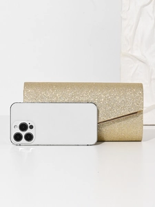 Detailed size comparison of the gold glitter evening bag next to a smartphone