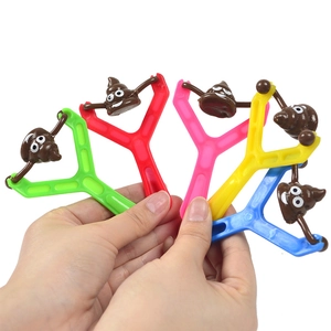 Five colorful plastic slingshots with funny emoji poo figures for stress relief fun