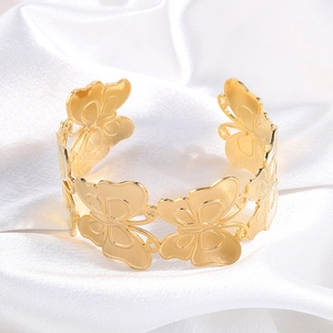 Macro view of golden hollow butterfly cuff bracelet with intricate wing textures