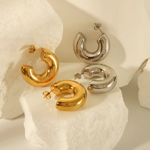 Minimalist 18K gold and silver chunky C-shaped hoop earrings set on white stone
