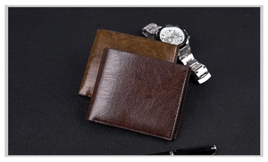 Close-up of vintage textured leather wallets in brown tones with business accessories