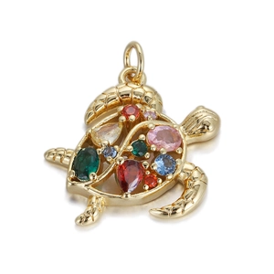 Macro shot of gold turtle pendant featuring colorful zircon stones on white background