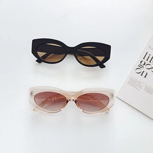 Retro round frame sunglasses in black and pink tints on a minimalist background