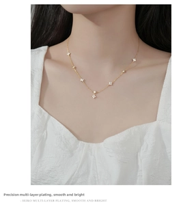 Detailed view of s925 silver four-leaf clover tassel necklace with zircon inlays