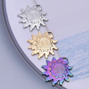 Detailed close-up of sunburst spiral pendants in silver, gold and rainbow finishes
