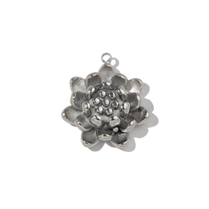 Macro shot of silver lotus pendant with polished finish and intricate petal details