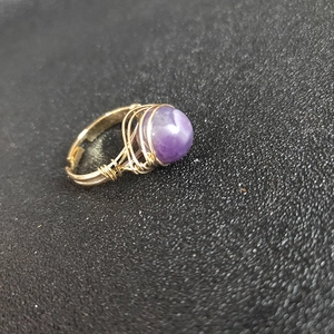 Handmade wire wrapped gold ring with round purple amethyst gemstone and open design