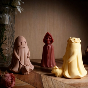 Detailed Halloween ghost and skeleton candle figures with matte finish and dried flowers