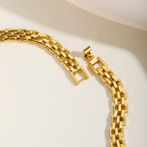 Detail of a polished gold stainless steel watchband link bracelet with folding clasp