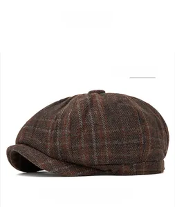 Close-up of a brown plaid wool newsboy cap with classic retro checkered pattern fabric