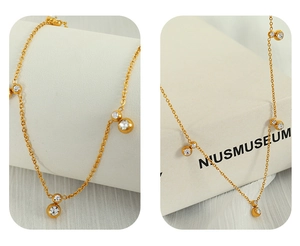 Detail view of gold-plated double-circle pendant necklace with sparkling zircon stones