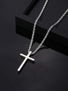 Polished stainless steel cross pendant on rope chain displayed on a black reflective surface
