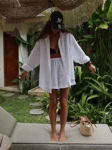 Linen long sleeve shirt and shorts set for women in white shown in a resort setting