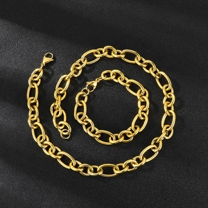 Detailed top view of gold-tone chunky stainless steel chain necklace on black texture
