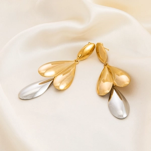 Two-tone 18K gold plated stainless steel leaf and teardrop earrings on silk background