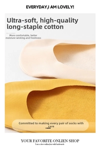 Detailed macro view of high-quality long-staple cotton texture in beige and yellow low-cut socks