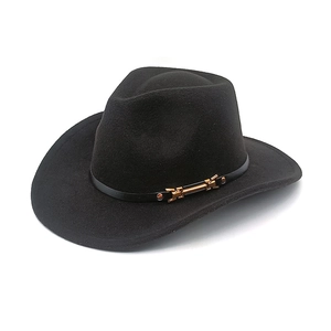 Detail of classic black wool cowboy hat with thin band and golden buckle accent