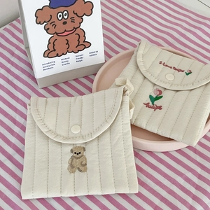 Detailed view of quilted cotton sanitary napkin pouches with bear and tulip embroidery