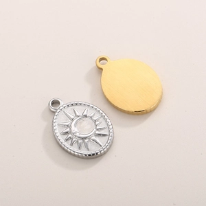Detailed macro view of oval sun and moon pendants in silver and smooth gold finish
