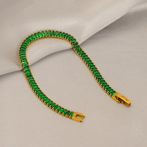 Elegant gold-plated tennis bracelet with emerald-cut green cubic zirconia on silk