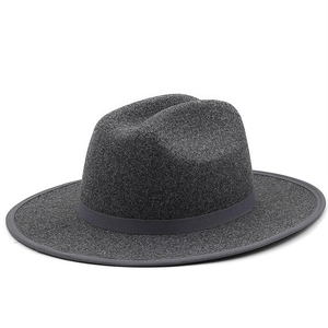 Detail view of a charcoal gray wool fedora hat with a classic grosgrain ribbon and wide brim