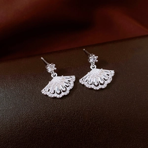 Detailed view of silver fan-shaped earrings featuring sparkling pavé cubic zirconia