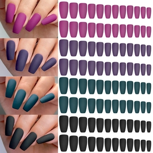 Detail of matte short press-on nails in pink, purple, teal, and black colors
