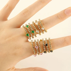 Detail showing stacked 18K gold heart rings with colorful zircon inlay on fingers