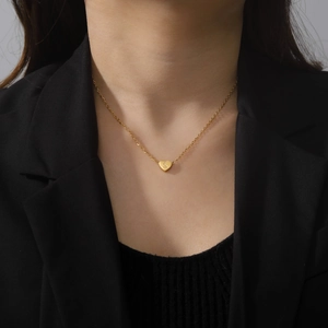 Minimalist gold heart necklace with letter S engraving on a fine cable chain for women
