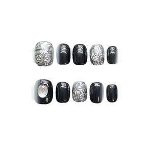 Handmade black flash press-on nails with silver relief texture and rhinestone accents