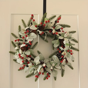Macro detail of Christmas wreath with red berries, pine cones and black door hook